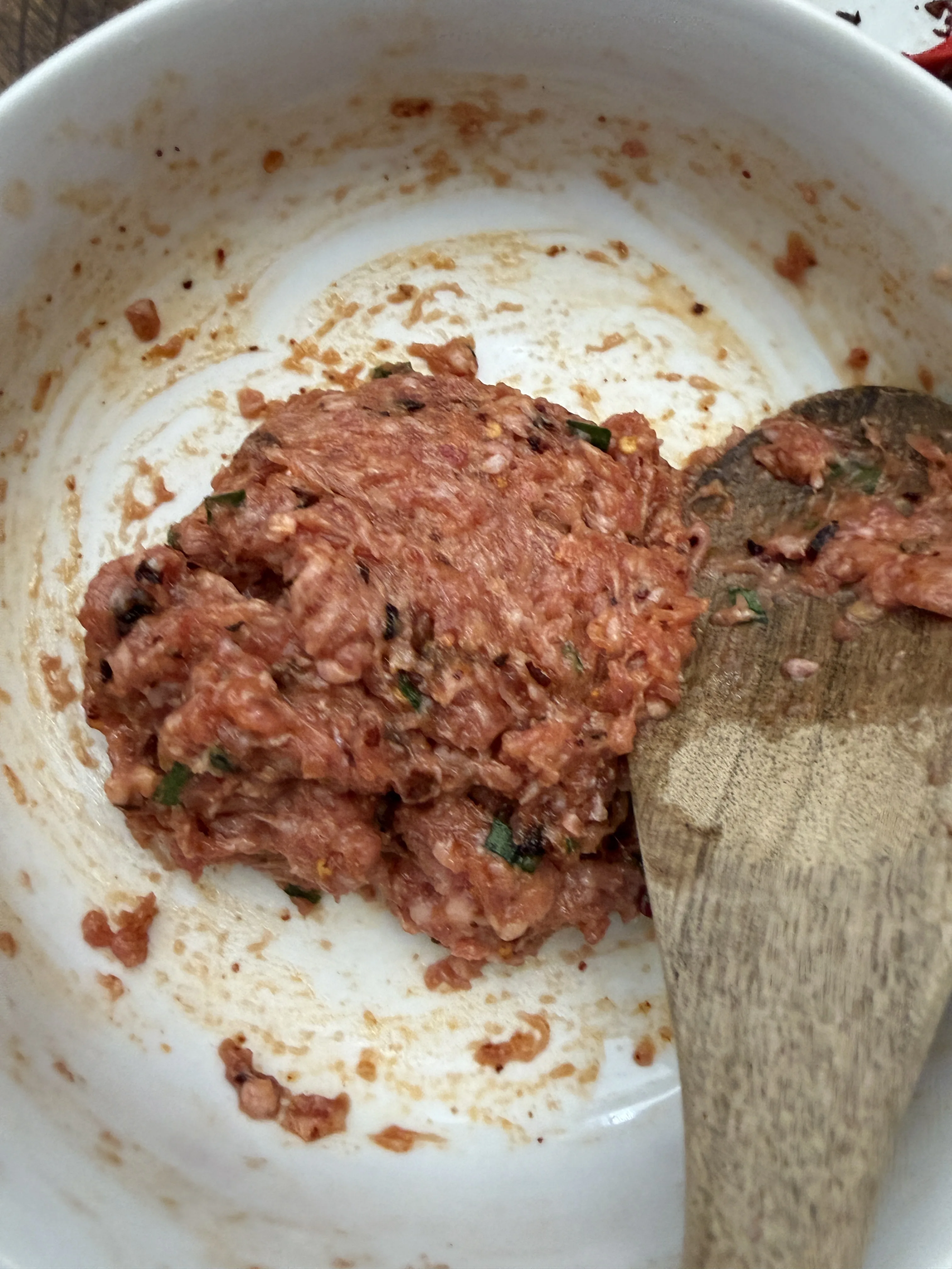 Finished pork dumpling filling with chopped Chinese chives mixed in