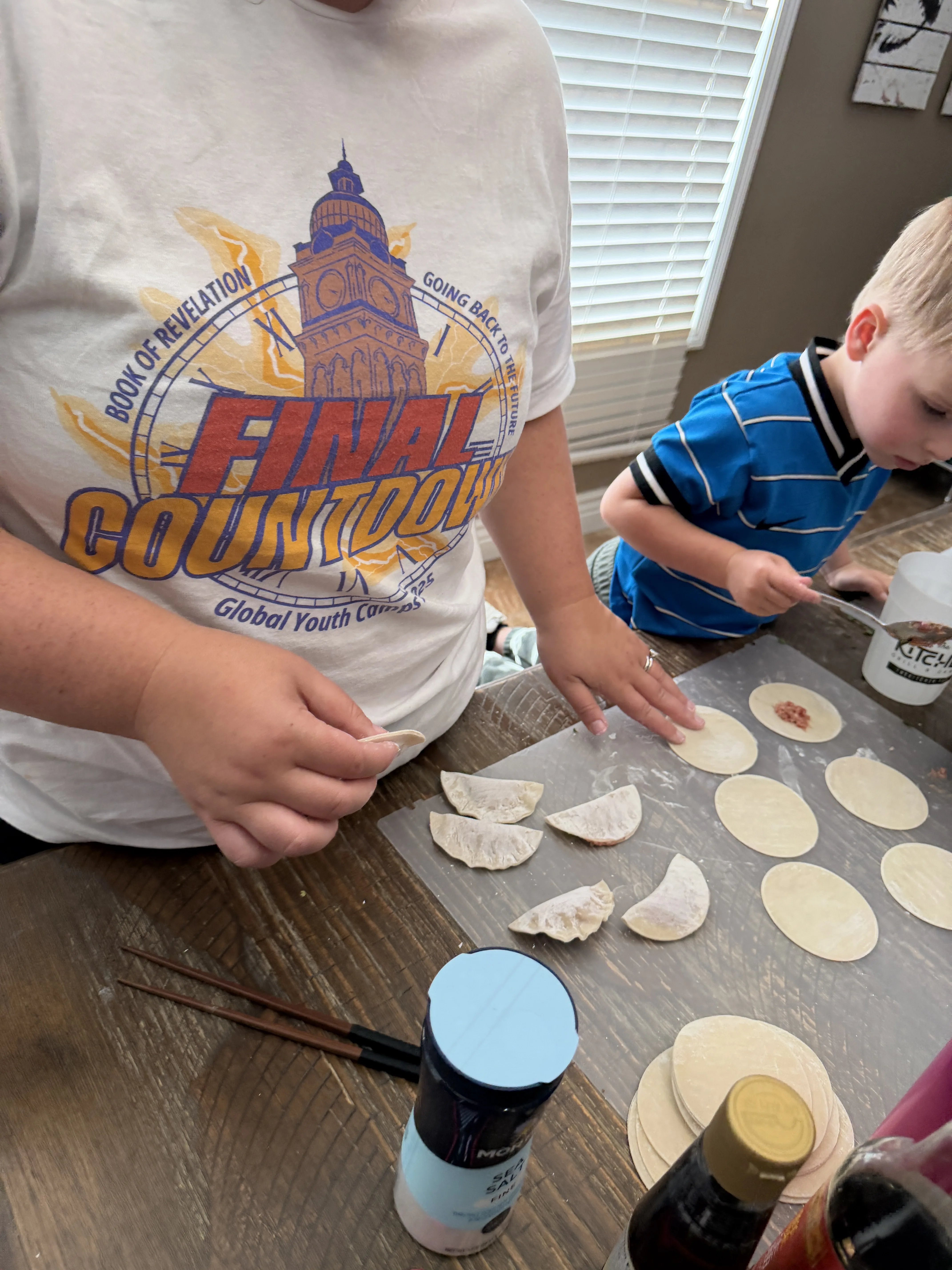 The McGennis family wrapping dumplings together at the kitchen table