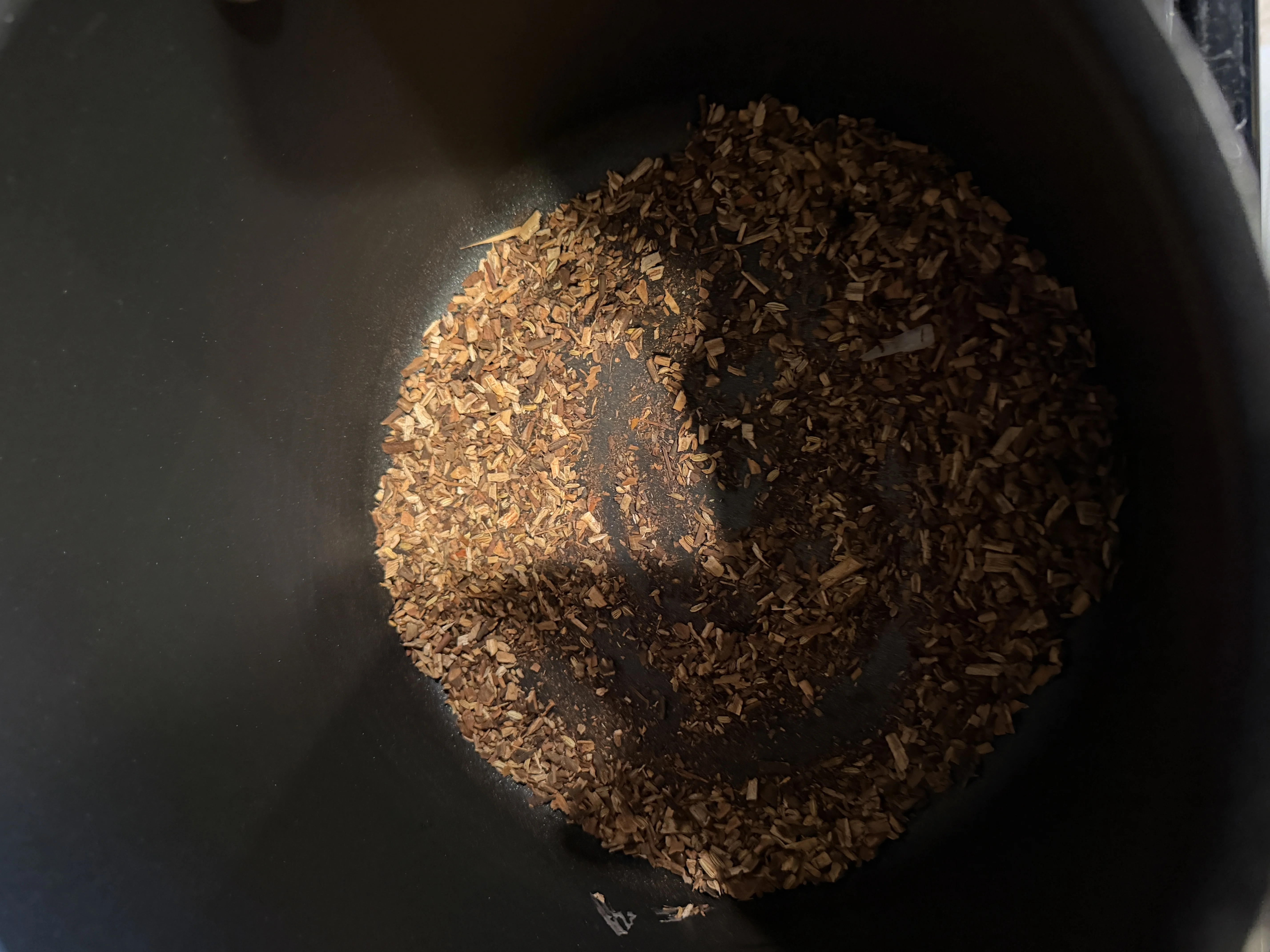 Toasting pho spices - star anise, cinnamon, cloves, and coriander in a pot