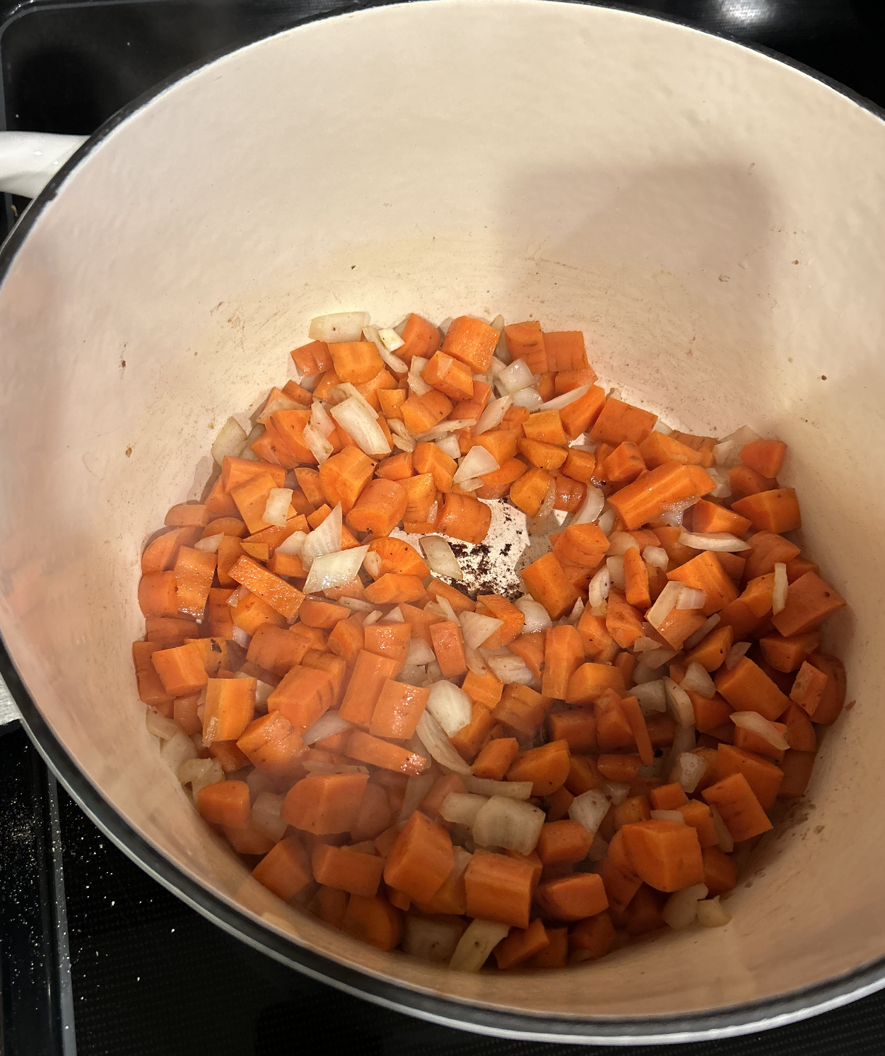 Carrots and onions cooking in pot